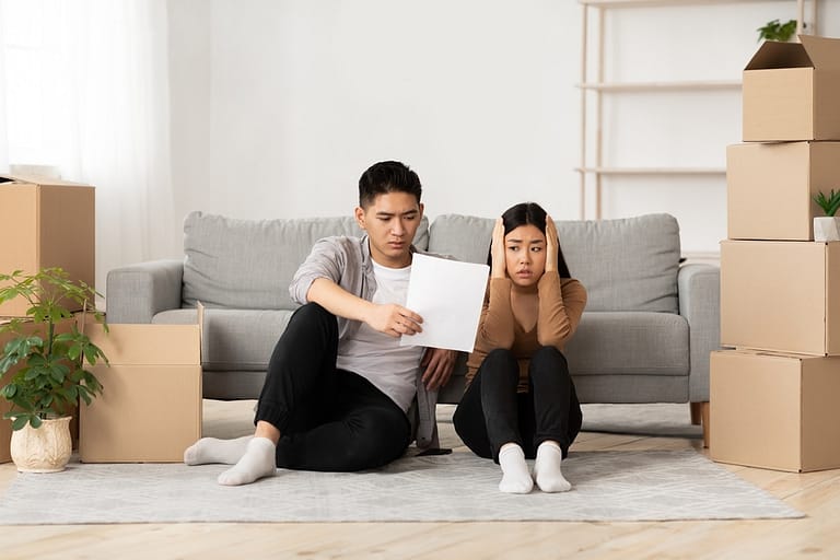 Asian man showing his shocked wife eviction notice
